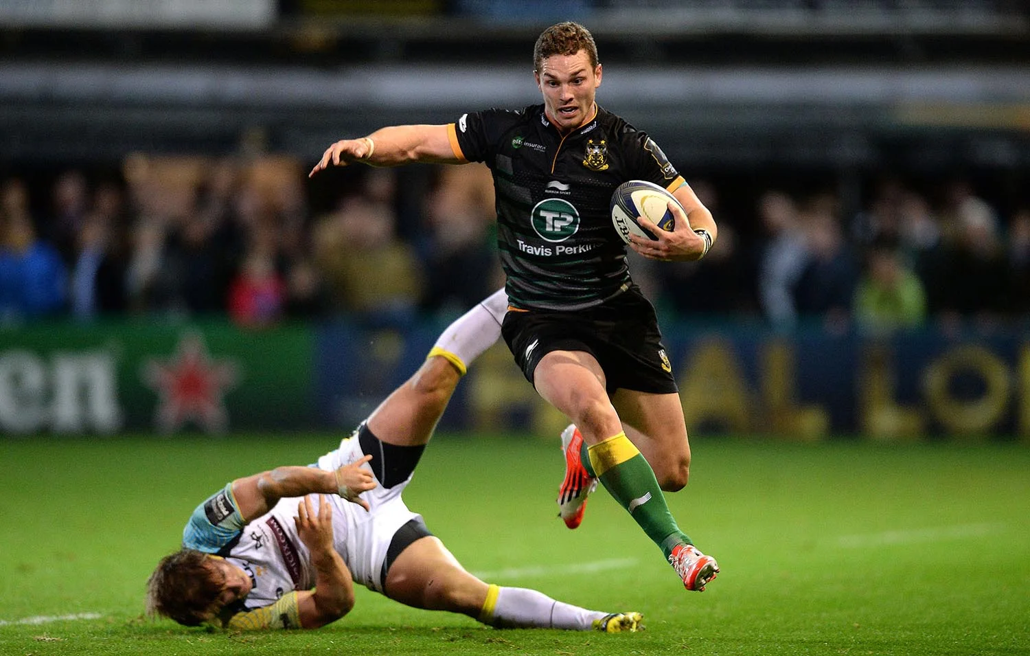 George North of Northampton is tackled by Jeff Hassler of Ospreys