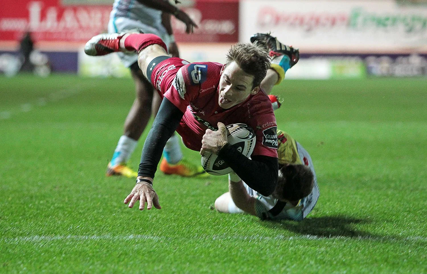 Liam Williams of Scarlets beats Martin Roberts of Ospreys to score