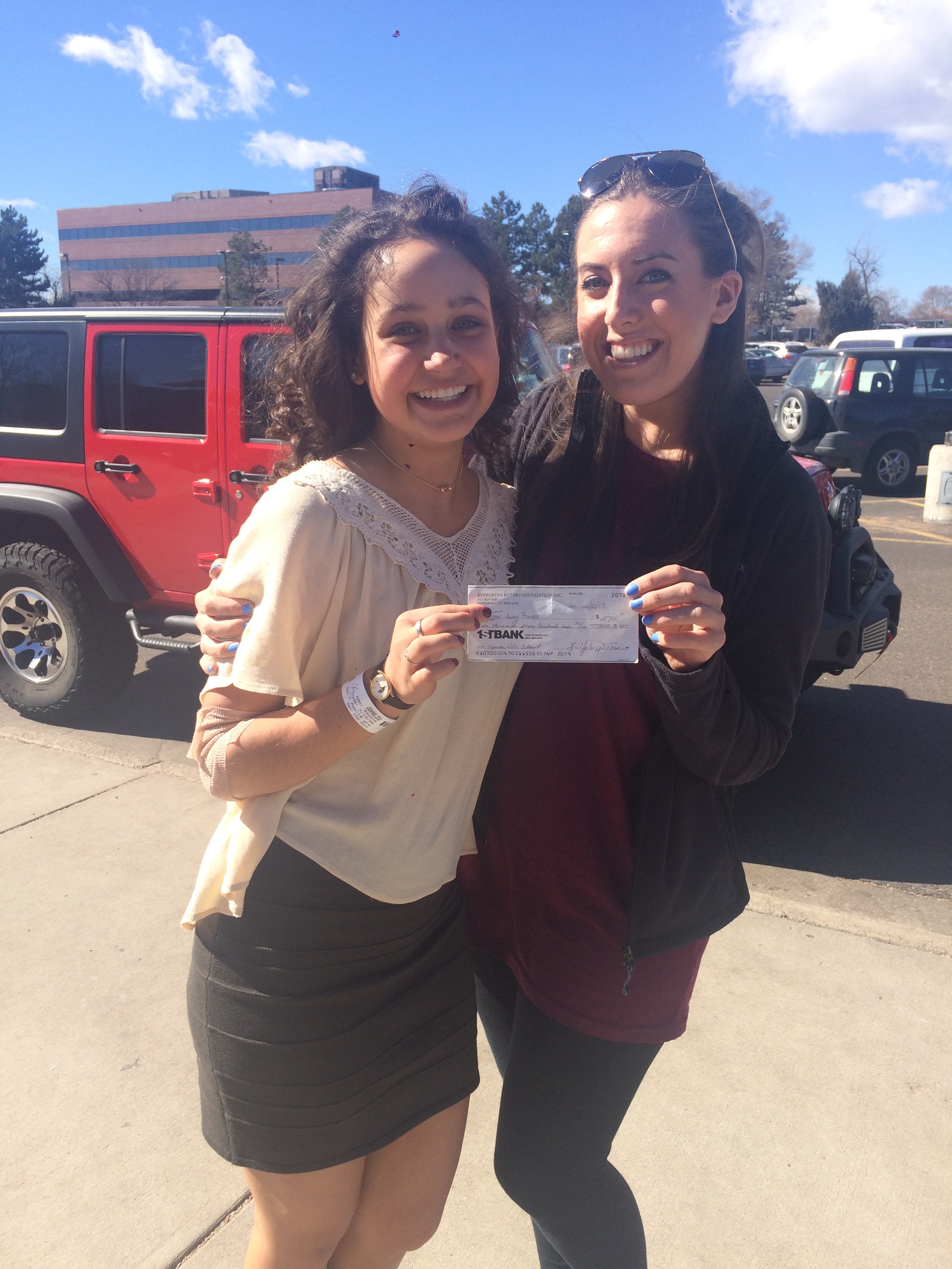 Zoi Johns (left) presenting her final check to our Executive Director, Jayme Ward. 