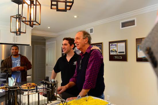 Father and son. Together for the cutting of the cake, Tony West at left.