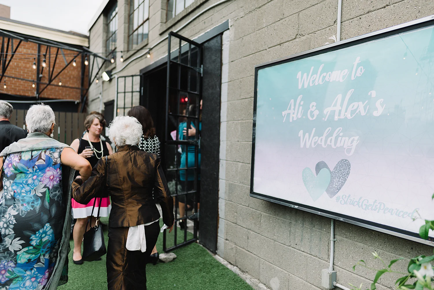 torontos-best-wedding-photographers-ryanne-hollies-photography-photojournalism-artistic-moody-toronto-airship37-graffiti-editorial-cocktail-hour-guests-mingling-homemade-graphic-design-sign.jpg