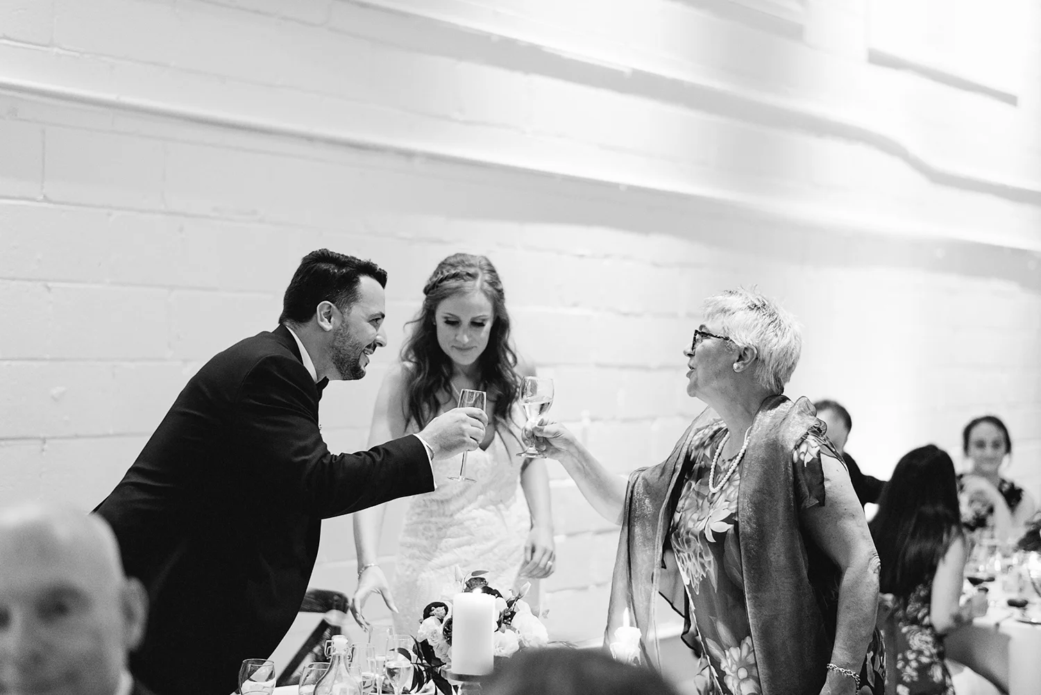 torontos-best-wedding-photographers-ryanne-hollies-photography-photojournalism-artistic-moody-toronto-airship37-graffiti-editorial-reception-bride-and-groom-speech-cheers-with-mom.jpg