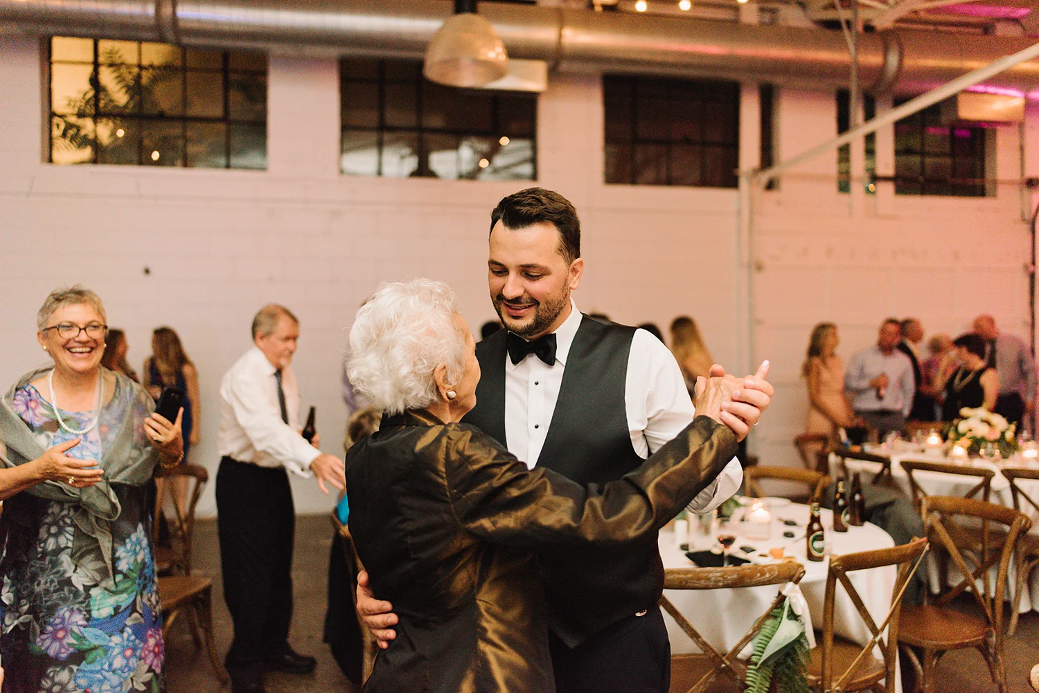 torontos-best-wedding-photographers-ryanne-hollies-photography-photojournalism-artistic-moody-toronto-airship37-graffiti-editorial-reception-dancing-together-hilarious-good-times-memories-dancing-partying-photos-grandmas-hugging-groom.jpg