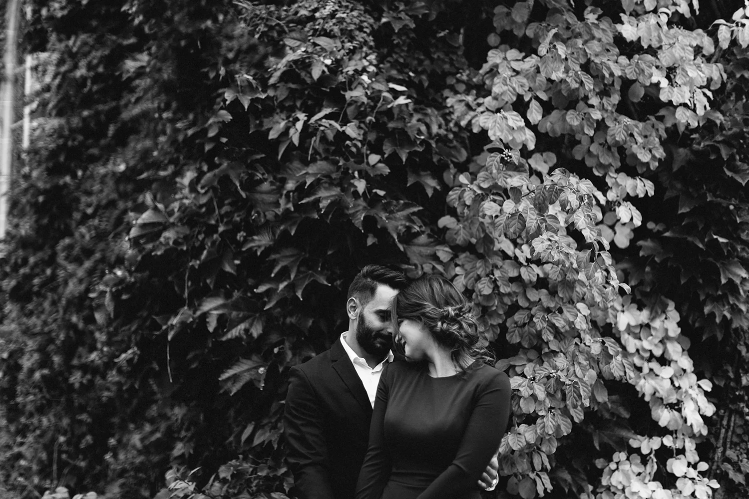 bw-toronto-restaurant-elopement-small-wedding-intimate-portraits-of-bride-in-purple-jumpsuit-old-ivy-buildings.jpg