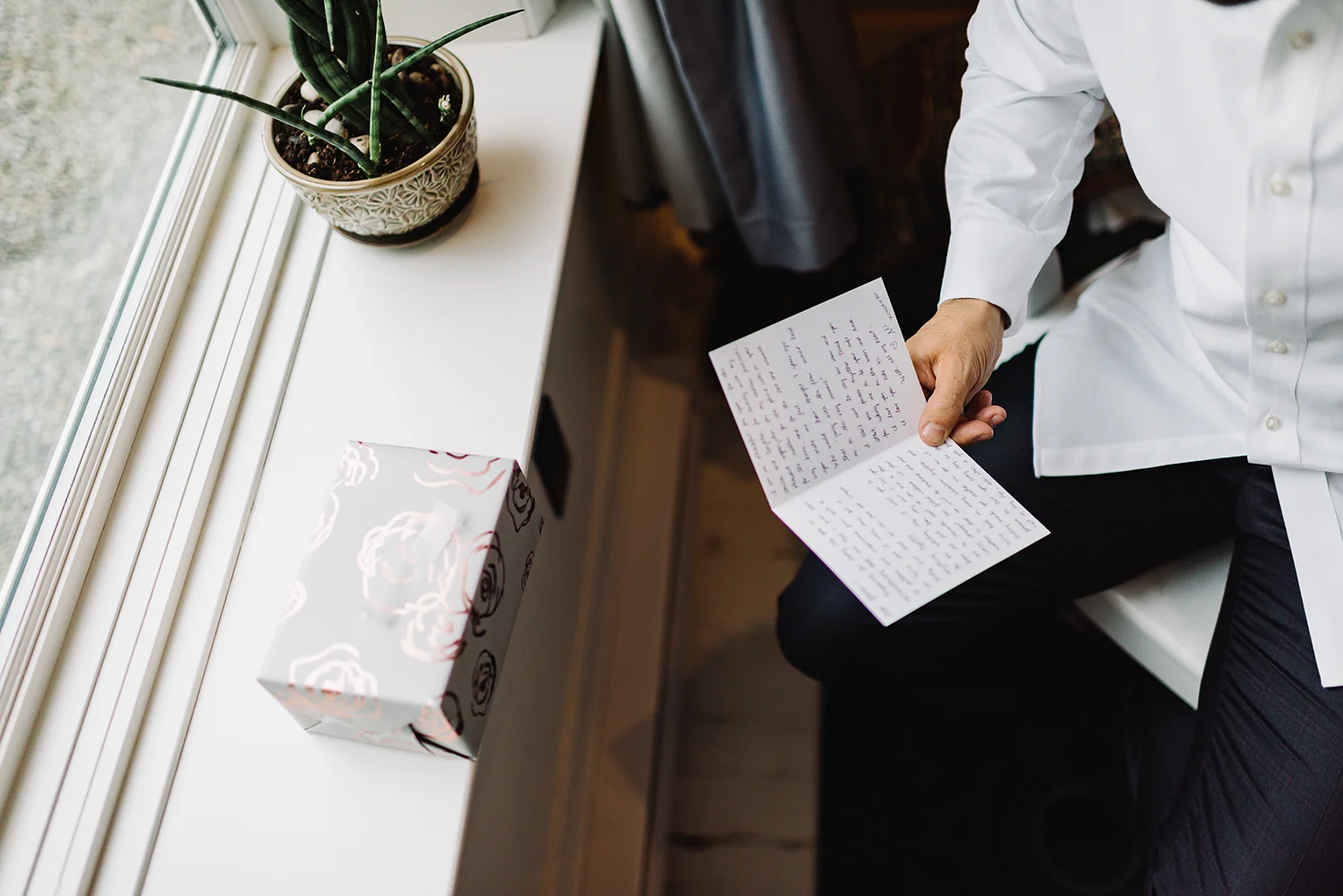 Prince-Edward-County-Drake-Hotel-Elopement-Ryanne-Hollies-Groom-Getting-Ready-Reading-Letter.jpg