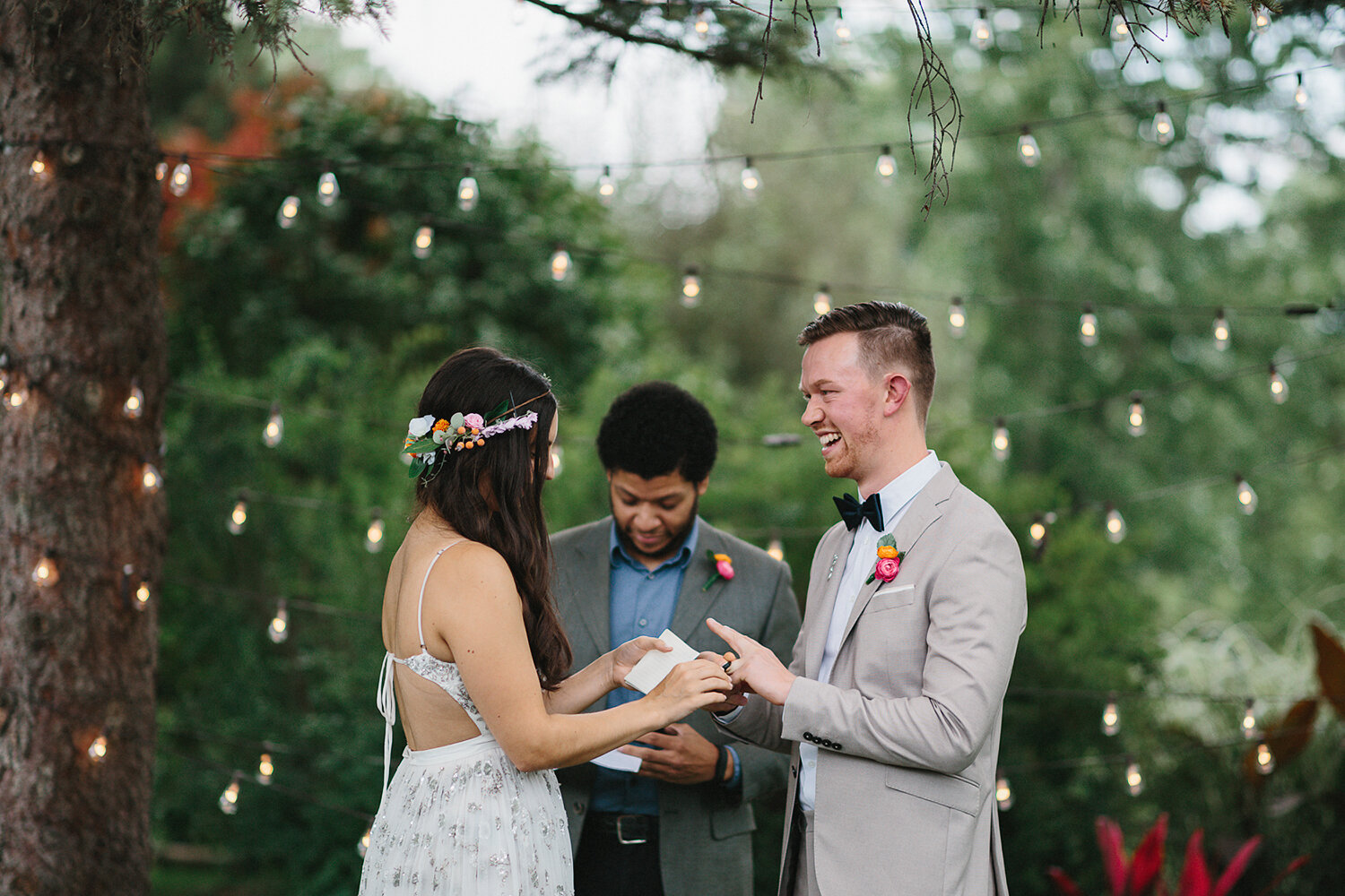 Backyard-family-intimate-cottage-wedding-chatum-kent-toronto-ontario-film-photographer-ryanne-hollies-photography-diy-string-lights-ceremony-space-lanterns-groom-and-bride-ring-exchange-emotional-smiles-cool-trendy-hipster-groom-laughing.JPG