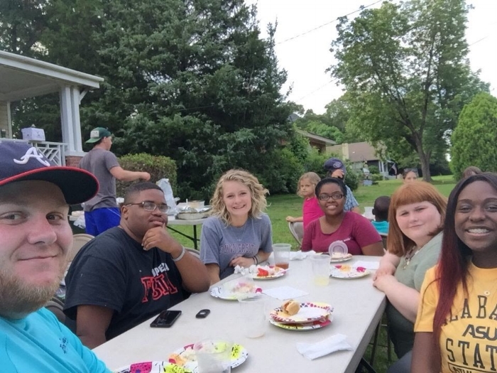 QuadW Missional Interns in Opelika at welcome dinner on their behalf as they begin their summer of living and serving together