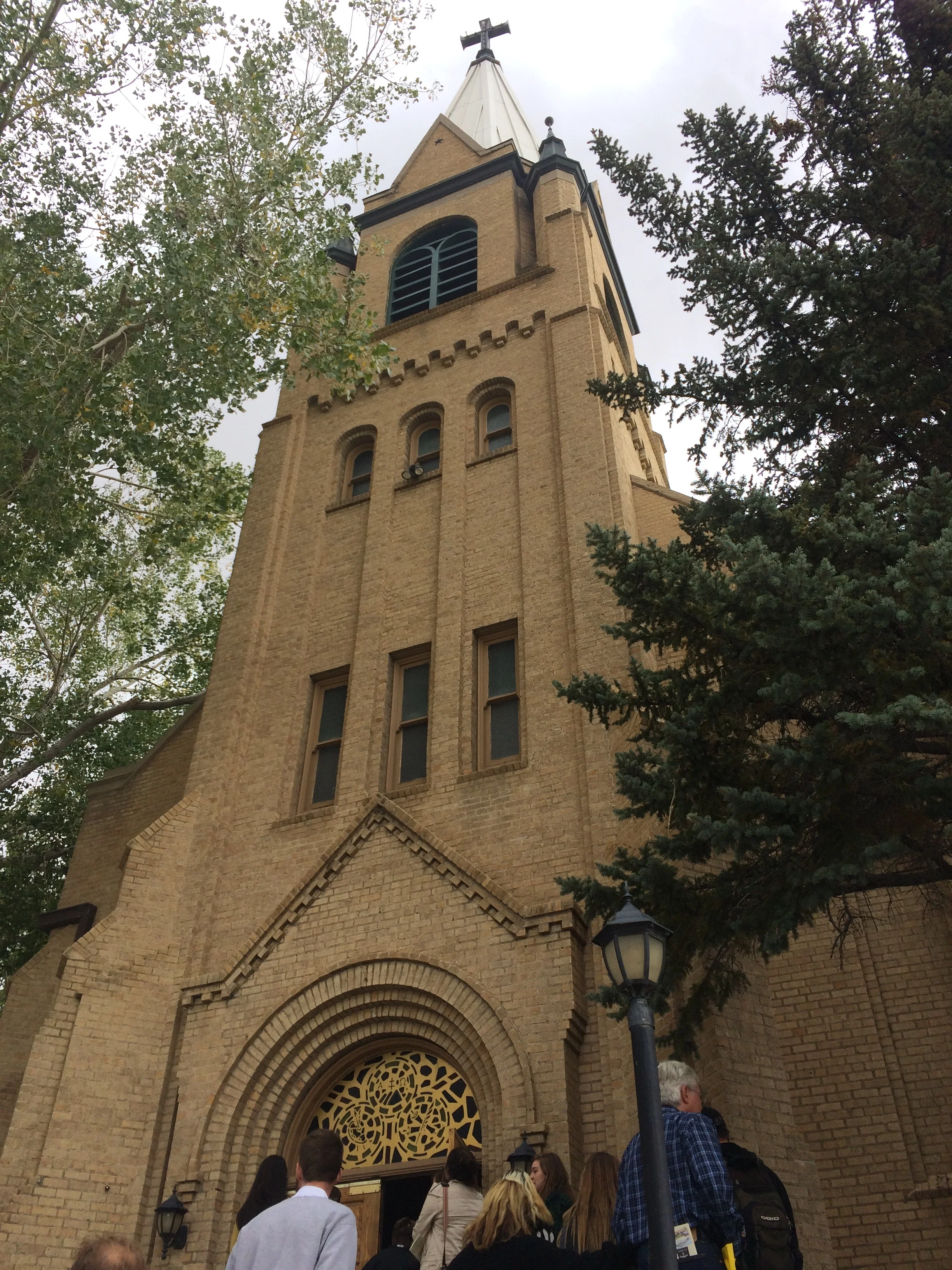 The facade of the church features a large square tower capped with a spire