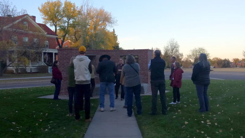 Intern Rine Kasckow tells tour-goers the story of the Balangiga bells during AHW's Unbarred tour at F.E. Warren Air Force Base
