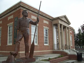 One armed John Wesley Powell stands in front of the Museum, which was the originally a Post Office