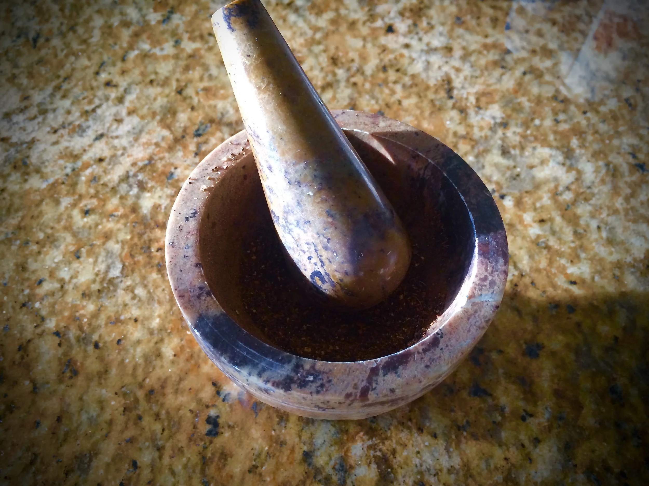 crushing up the dry chai tea, taken straight from the bag and into my mortar & pestle.