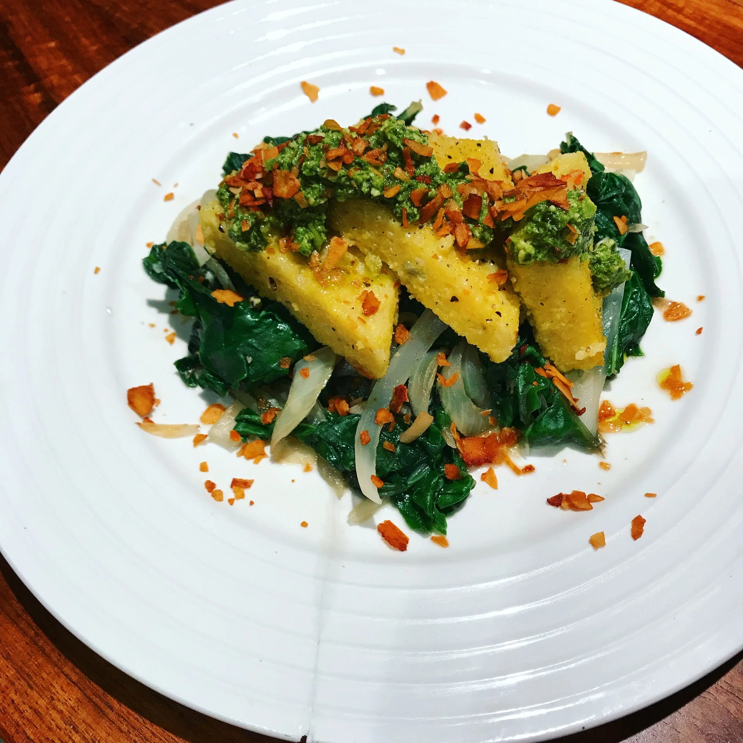 Polenta triangles I fried in a bit of oil, put them on top of more greens and topped with my favorite coconut bacon "Faken Bacon". What you can't tell from this picture is that they did not have a even golden-crisp to them. Improvement was definitely needed! 