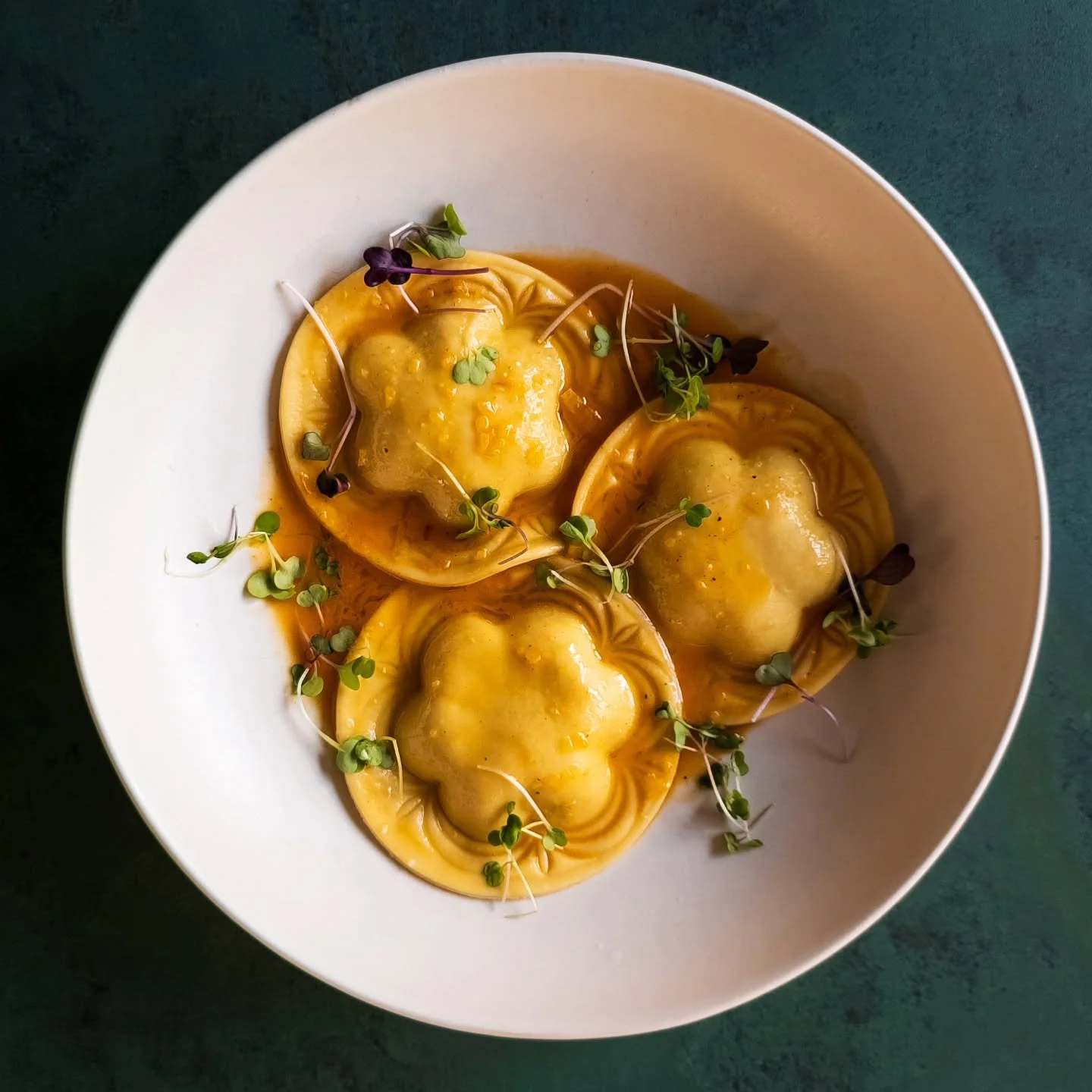Four cheese ravioli in a light sauce of chicken stock, tomato paste, and butter. I love this shape and how well it holds up after cooking! The mold shape was inspired by the multifoil designs found in Gothic windows.