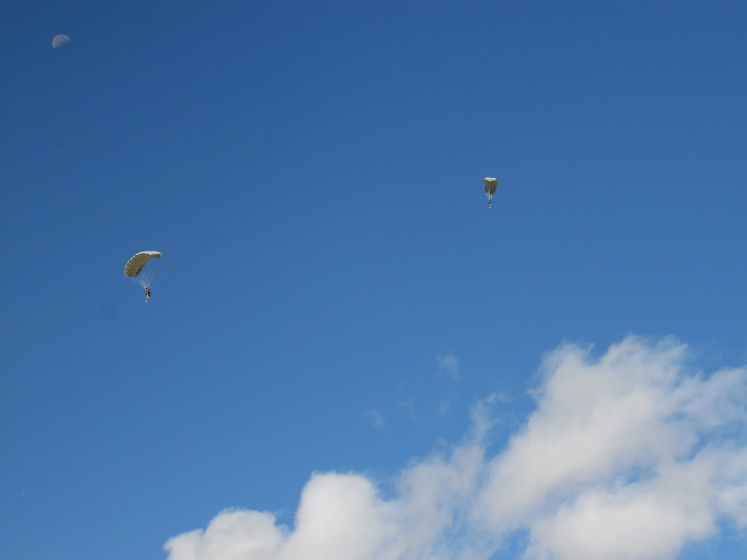 Two members of the Complete Parachute Solutions team gliding down to land. 
