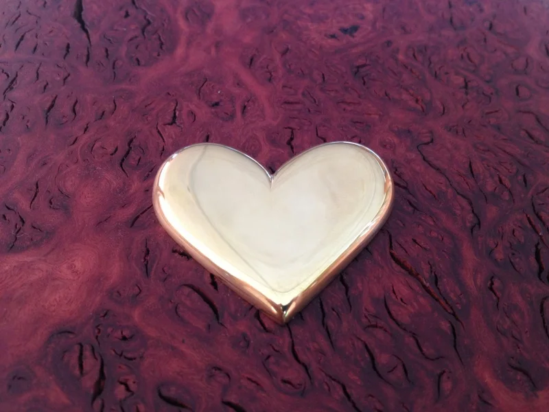 Hand shaped brass heart