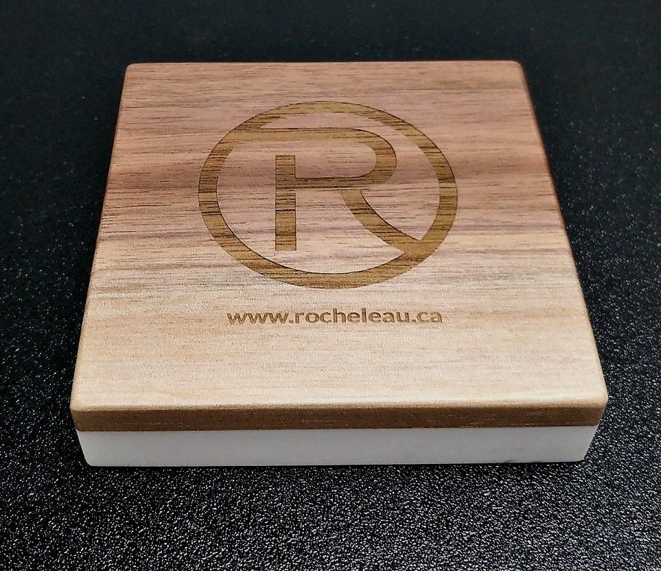 Un dessous de verre en bois avec le logo 'R' de Rocheleau marqué par Systana Gravure Laser