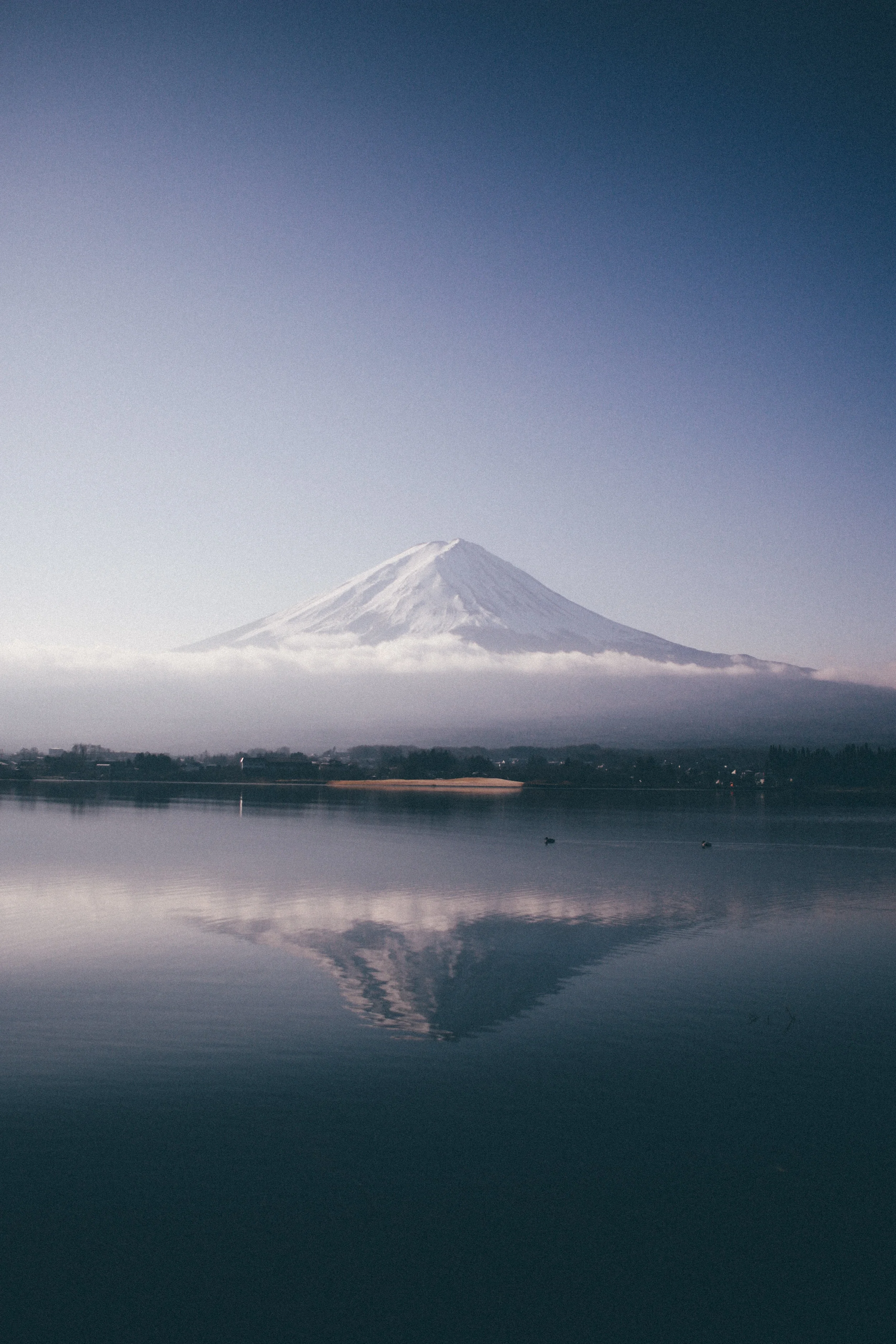 11. MORNING FUJI This shot is really special to me. I remember the morning vividly. My friends, the Lims, and I were driving to go see the snow near Fuji. As we got closer and closer to the mountain, the views just kept getting better and better. We decided to pull off to a lake and see if it was a good view, and when we got there my jaw dropped. It was by far the clearest view of Fuji I had ever seen. I quickly got out of the car and walked down to the water when I saw and old man. He turned to me and started rambling off in Japanese telling me I needed to hurry it. I wasn’t sure what he was talking about, but once I got past the reeds of the water I immediately knew. The reflection. He was telling me to hurry, because the reflection on the water was absolutely spectacular. I snapped a few photos, this being one of them. About 5 minutes later, I looked back at the water and noticed the water was murky, the reflection gone, and a thick layer of clouds covering Fuji. I then realized just how lucky I was.