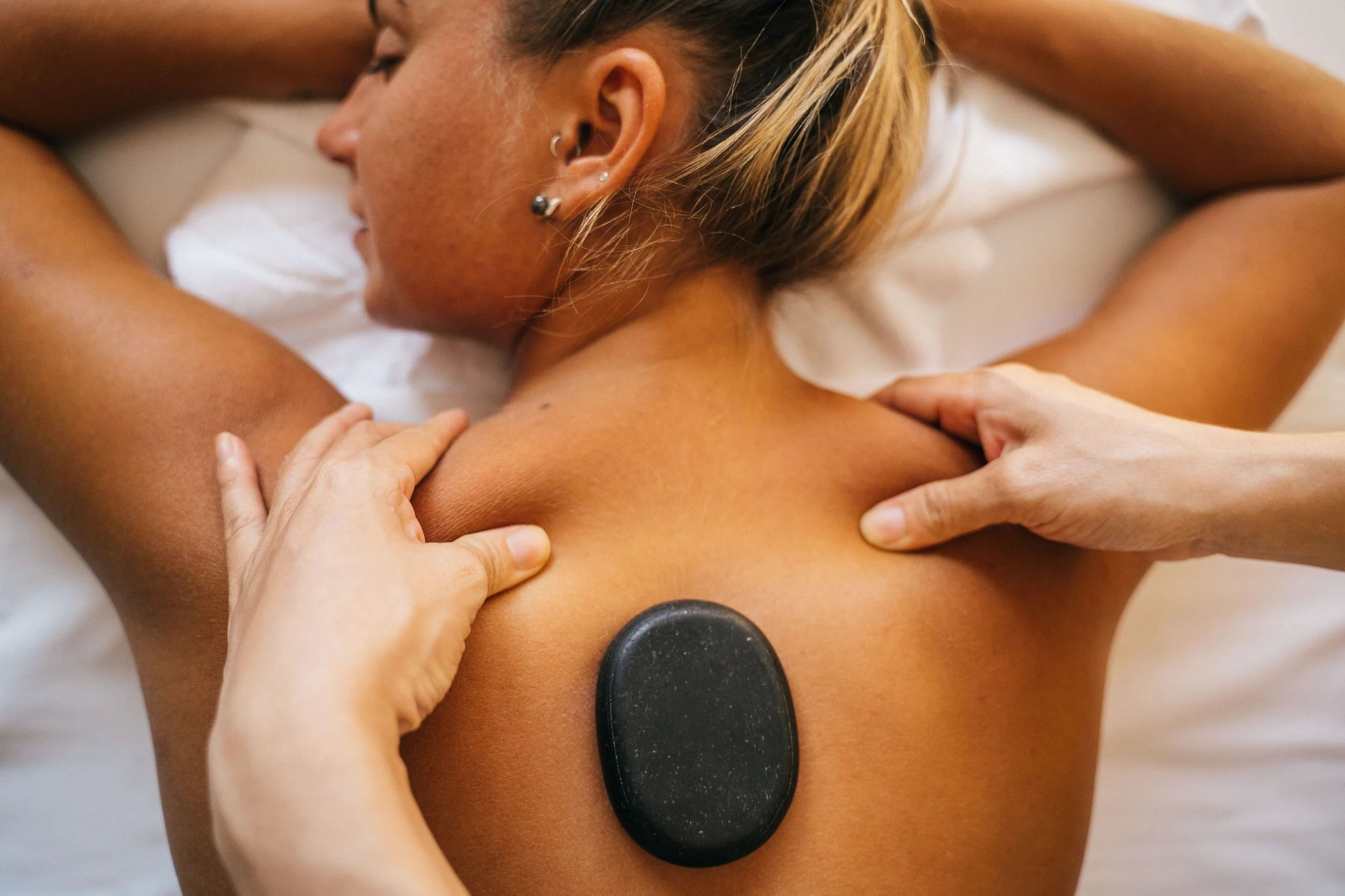 Hot stone massage for deep muscle relaxation at Pure Eco Spa