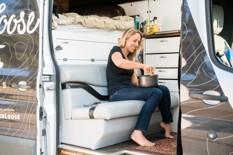 Lauren mixes up a batch of rice cakes in the living room/kitchen of Loosey - her van.