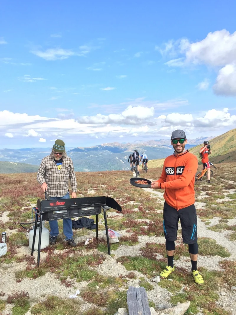 Uri's husband Jeff waits at the top of Wheeler Pass on the BreckEpic course to serve his wife freshly cooked bacon.