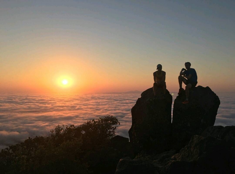 Embracing the moment with friends on the East Peak of Mount Tamalpais. Photo credit: Levi Miller @levimiller