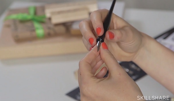 Calligrapher Bryn Chernoff show off a pointed nib