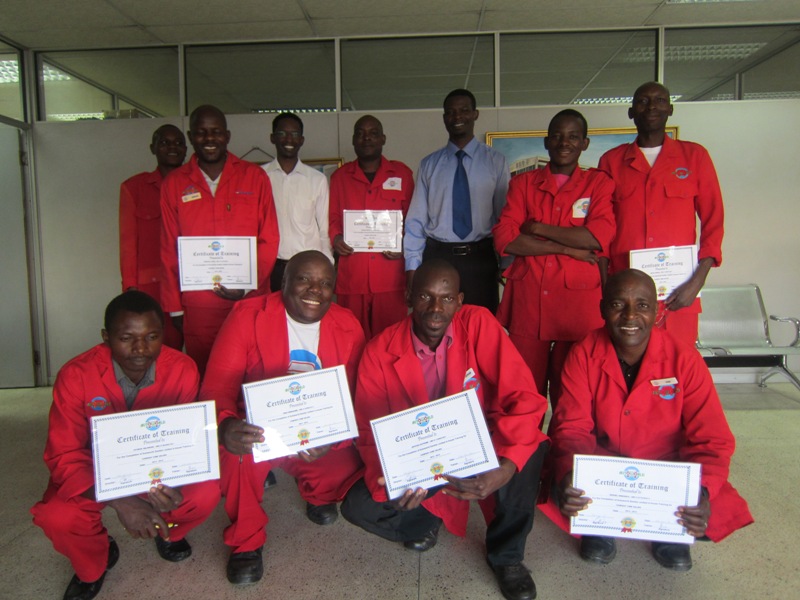 Drivers and support staff proudly display their certificates with Autoworld trainer Dr Davis Malembeka