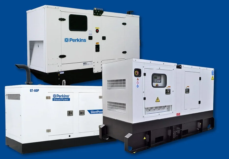 Two large red industrial batteries with black bases are placed on a paved surface outdoors.