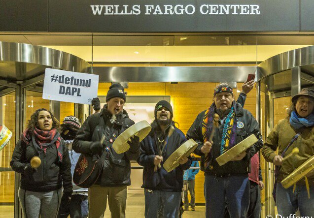 Rachel Heaton, Matt Remle, Jesse Nightwalker, Raymond L. Kingfisher and Paul Cheoketen Wagner outside of the Wells Fargo Center in downtown Seattle, January 5th 2017. Photo courtesy of John Duffy.