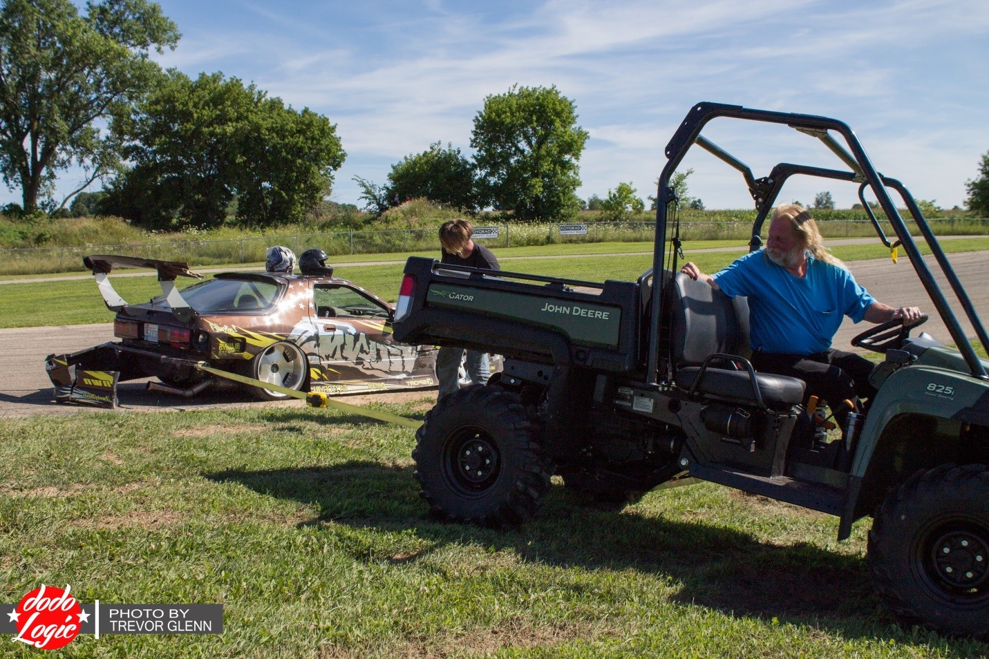 After another FC blew its motor, the owner allowed Jason to borrow his parts to get back out on the track. While doing so, he discovered that his rear bumper support had bent from the accident and was rubbing on the tire, so the staff offered an on-track frame pulling service!