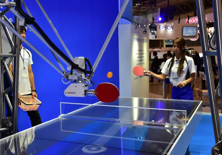 Japan's electronics maker Omron demonstrates a table tennis robot, which returns the ball to an opponent player, at a preview of Asia's largest electronics trade show Ceatec in Chiba, suburban Tokyo on October 6, 2015. Some 500 electronics companies and organisations are exhibiting their latest products and technologies at the show until October 10. AFP PHOTO / Yoshikazu TSUNO