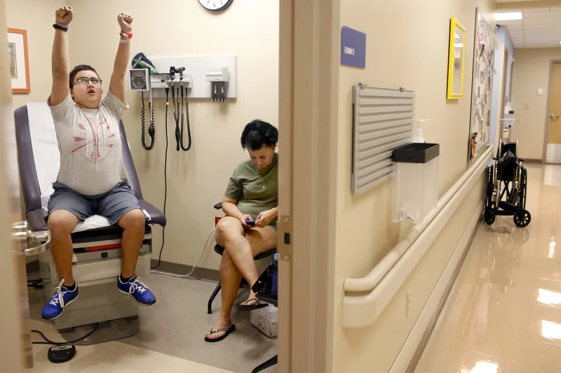 Ethan Arbelo, 12, waits for the oncologist with his mom, Maria Maldonado, shortly after a radiologist delivered news from an MRI that shows new tumors growing in his brain at All Children’s Hospital on September 24, 2013 in St. Petersburg, Fla. Mari