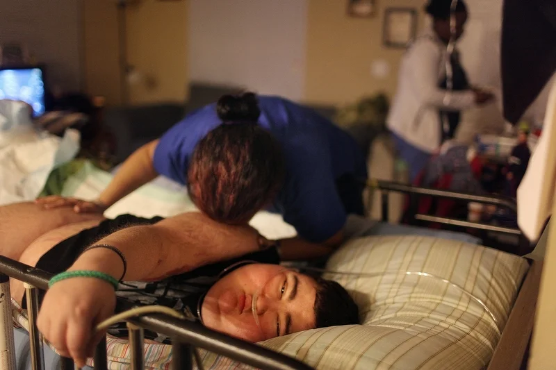 Maria Maldonado prepares Ethan Arbelo, 12, for sleep on May 21, 2014, in Lehigh Acres, Fla. Ethan was losing his eyesight due to the buildup of fluid inside his brain. “It feels like I’m losing my best friend,” Maria said. 