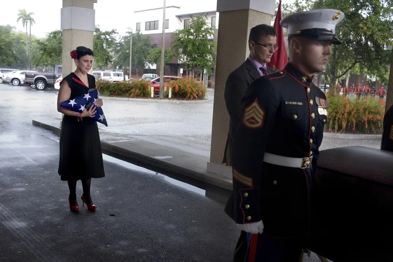 Maria Maldonado watches on as Marine pallbearers carry the casket containing her son, Ethan Arbelo. In October, Ethan was named an honorary Marine. He died with the rank of sergeant. “Thank you all for loving my little man,” Maria said during the fu