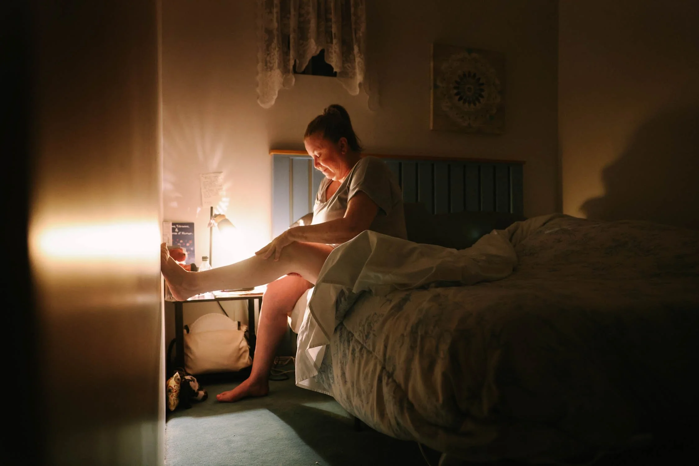 Gabriella Walsh takes her evening medicine and rubs cbd lotion on her legs on June 15, 2022 in Santa Paula, CA. She used a fentanyl patch, extra opioids—Norco—that she could take when needed, a blood pressure medication, Xanax, Ambien and Restoril.