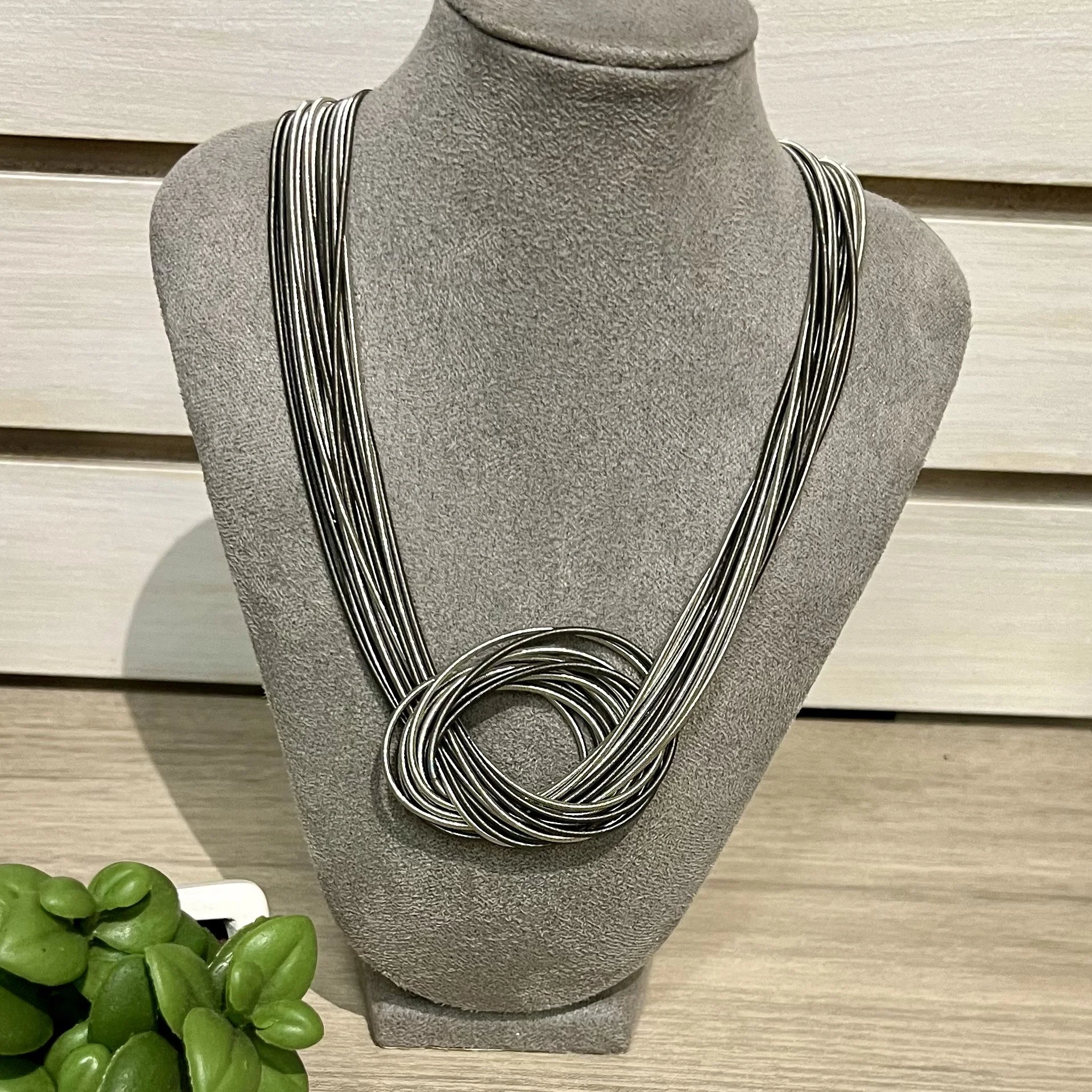 Piano wire knot necklace silver.jpg