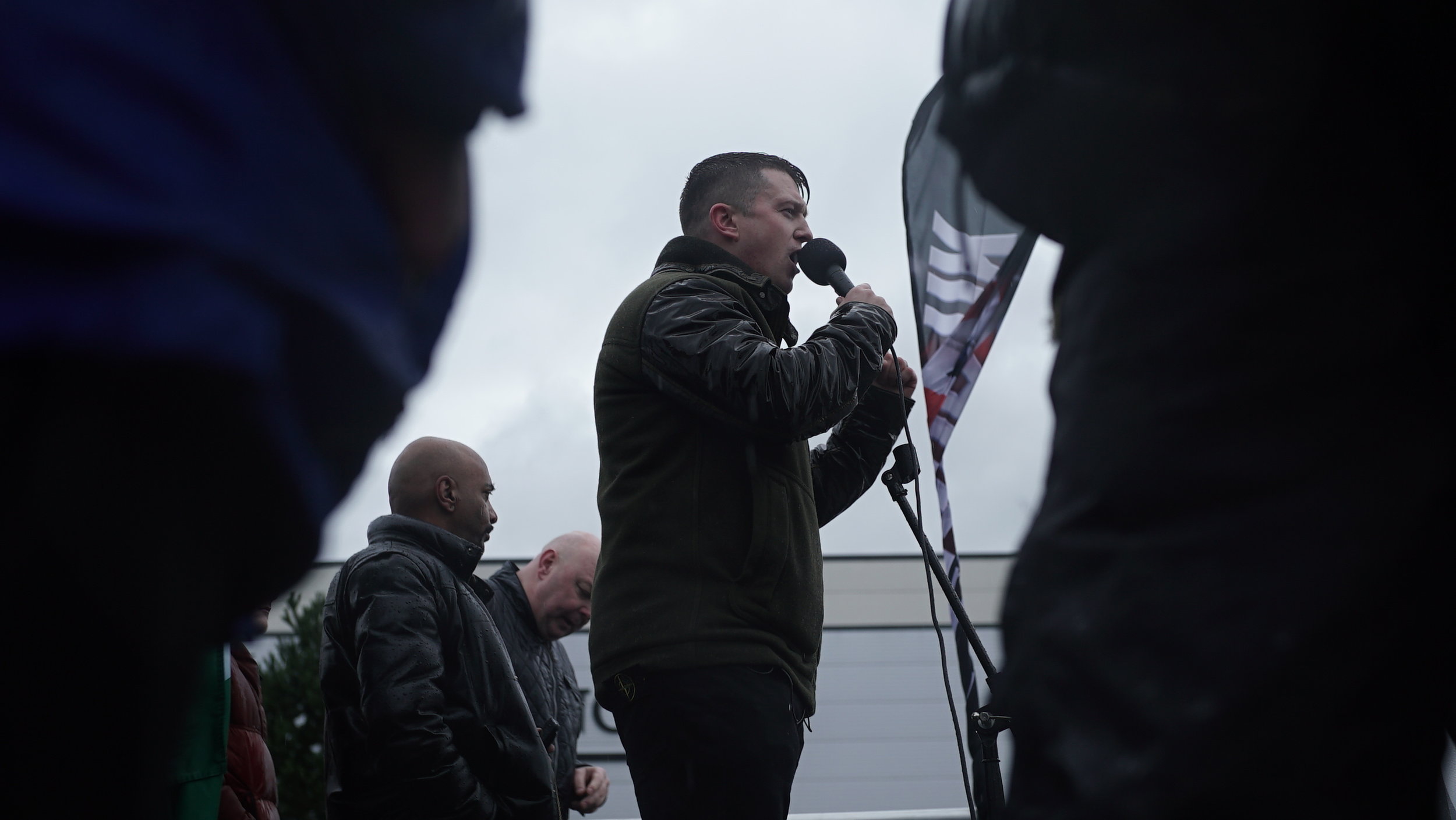  Far-right activist Tommy Robinson speaks to crowds at PEGIDA silent march.  Photo by Sarah McClure  