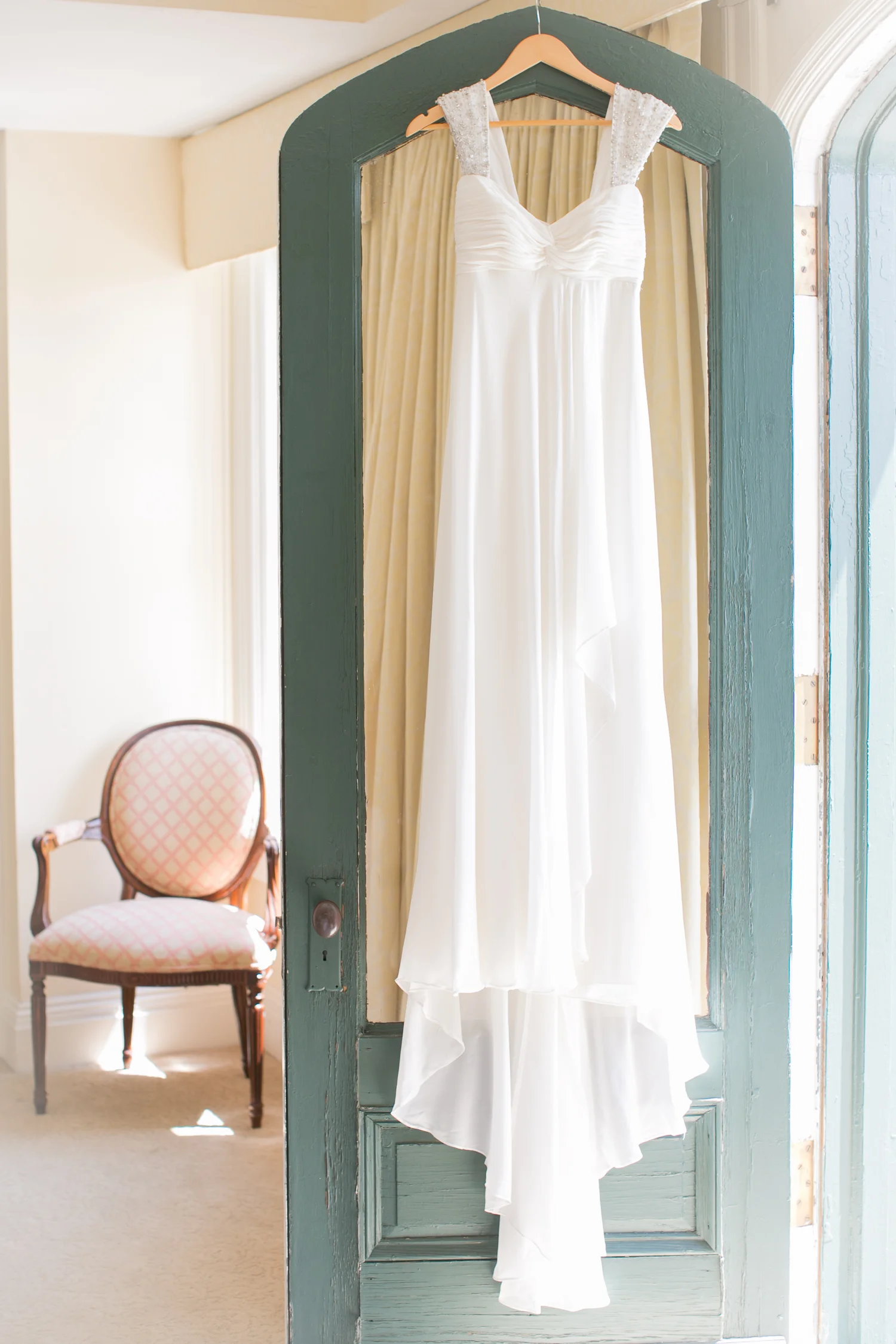 The bride's dress hanging in her dressing room