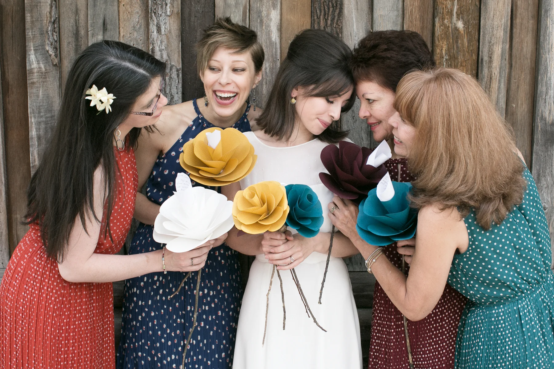 The bride and her bridesmaids before the ceremony holding custom bouquets