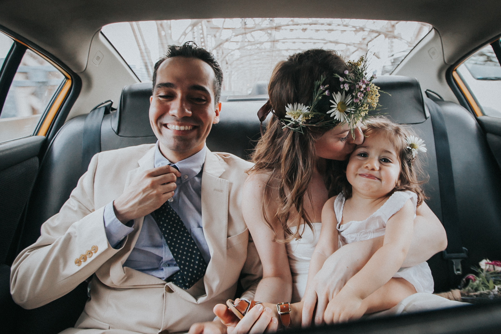  The bride and groom with their daughter, on the way to their ceremony via taxi 