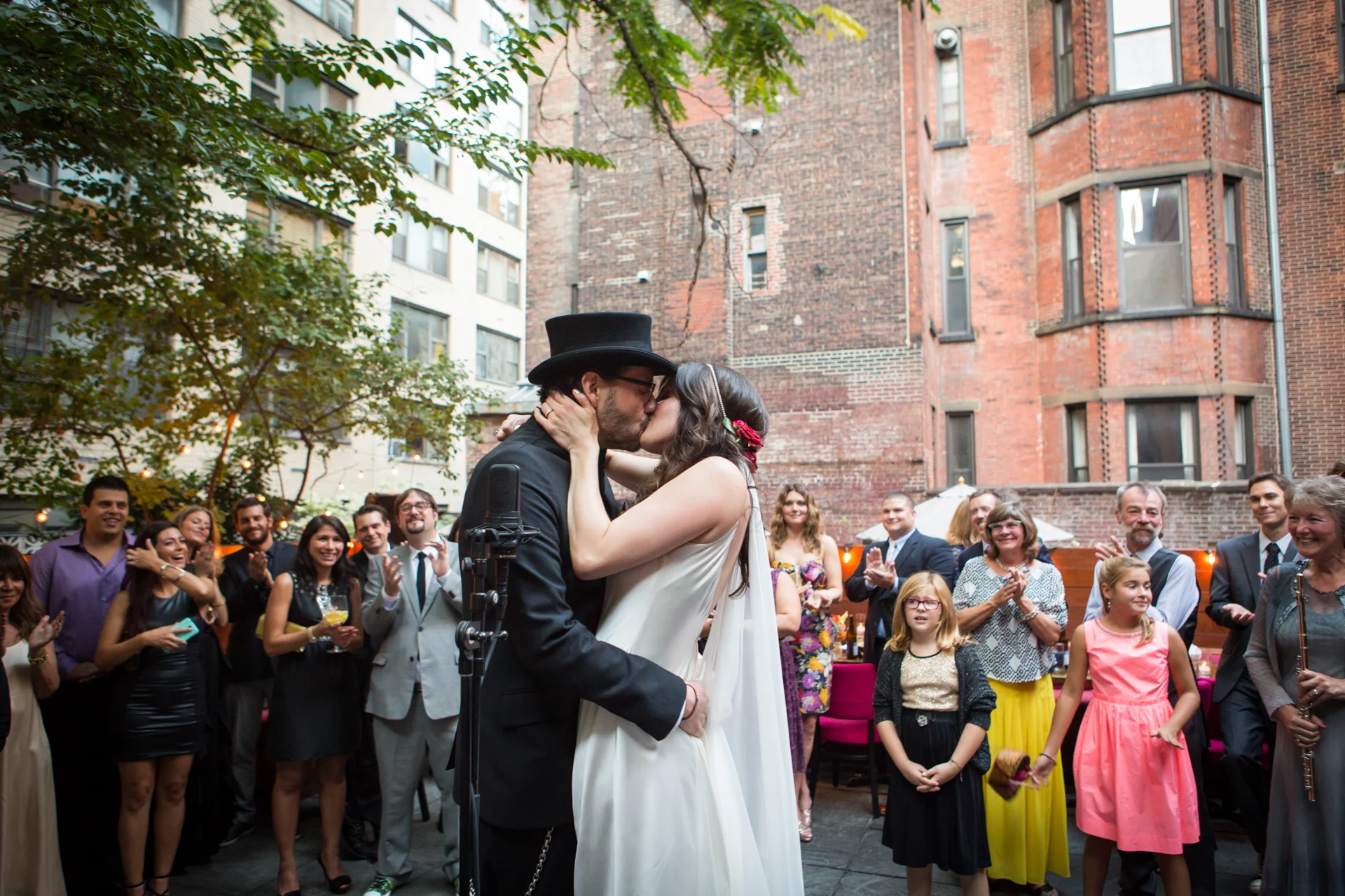 The bride and groom kiss for the first time during their wedding ceremony