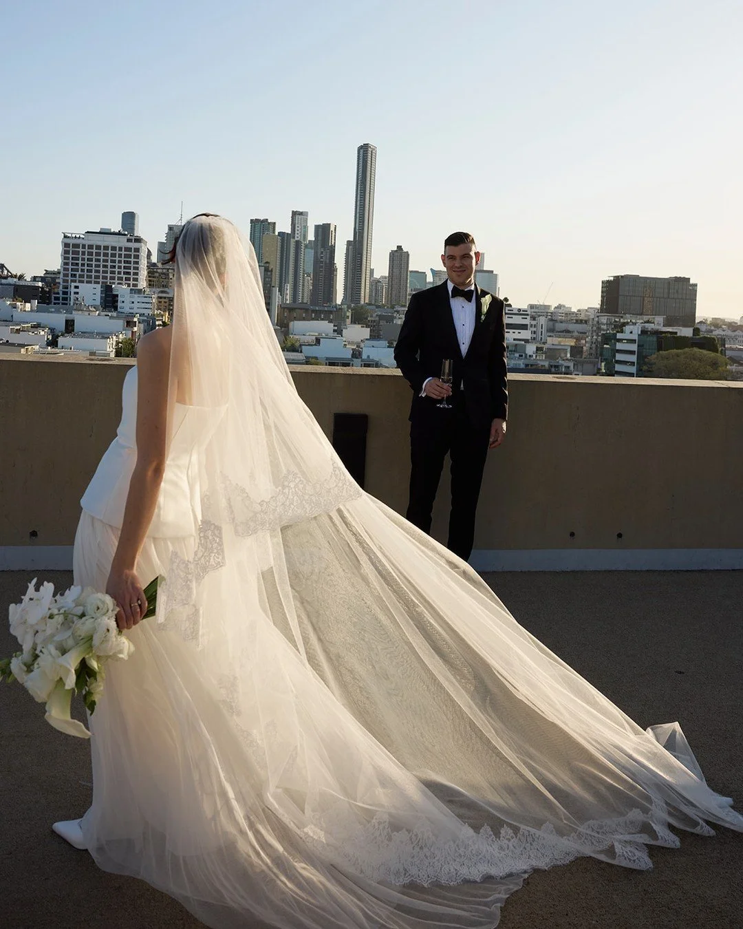 REAL BRIDE | Paris &amp; Vedad. 
An effortlessly chic, intimate celebration at @thecalilehotel.

Paris wore the Yolanda with a tulle neck tie and a traditional veil, creating a timeless, elegant look.

Bride: @pariselizabeth2
Groom: @vedofetahagic
Ph