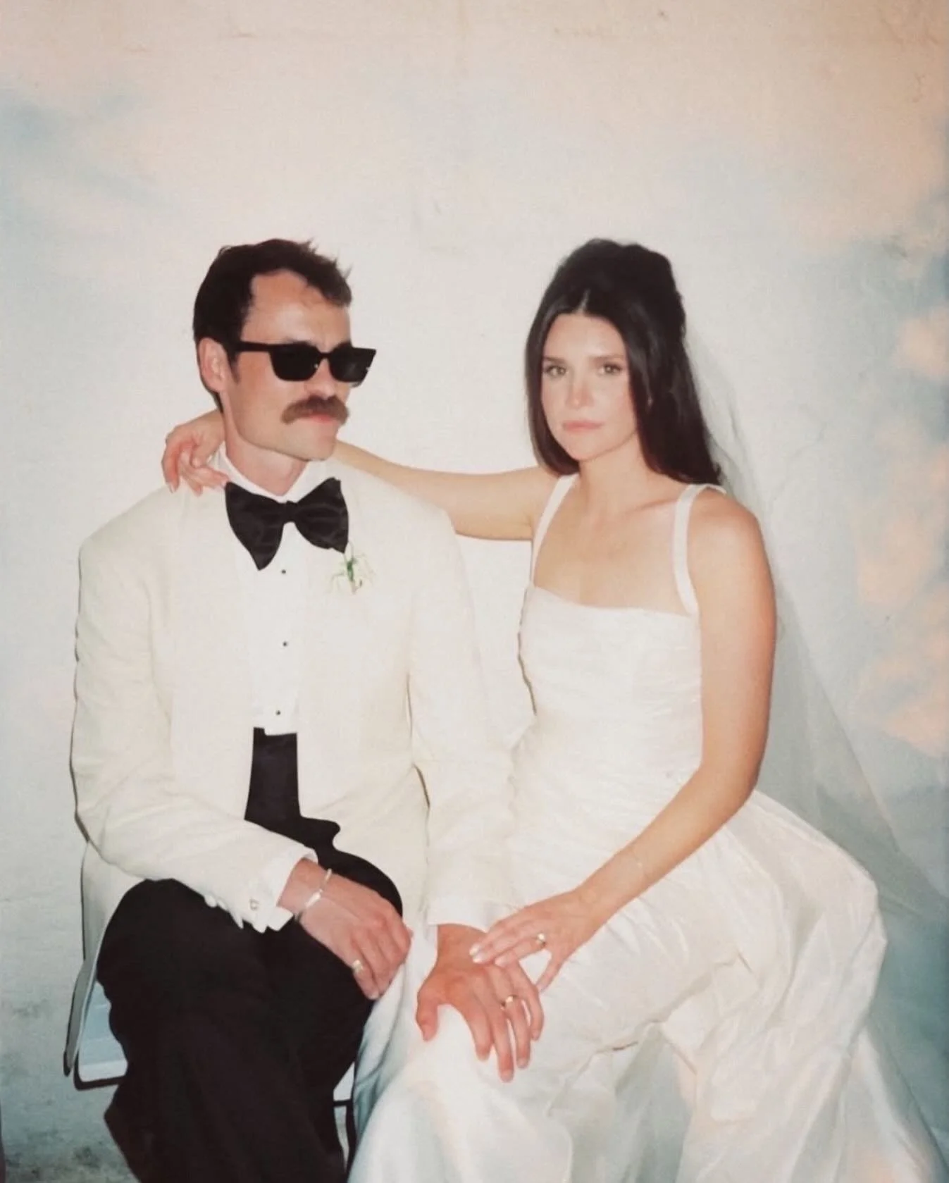 REAL BRIDE | Maddy + Nat ❤️&zwj;🔥 
⠀⠀⠀⠀⠀⠀⠀⠀⠀
Maddy wears the Gianna Dress with the Grace Overskirt &mdash; effortless, sculptural and timeless. 
Confident design choices set the tone.
Bold red tables, candlelight and a vintage aesthetic create a str