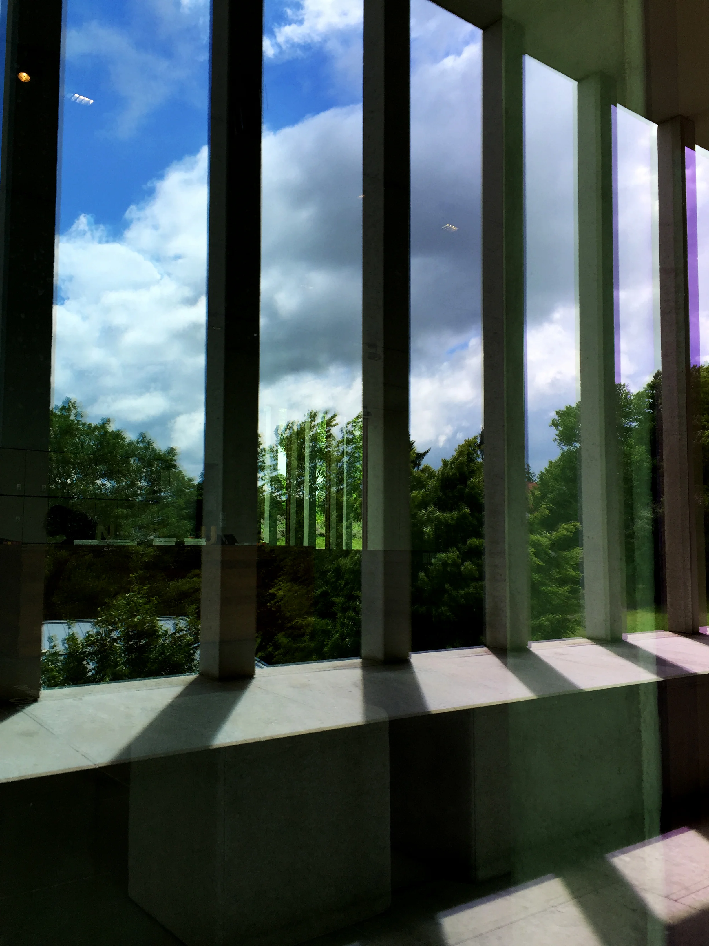 For me the multiple layers of views, reflections and shadows echo the complex points of view and layers of meaning within literature. No idea if that was the architects' intention but that's how I experienced this wonderfully simply yet complex layering of surfaces and structures.