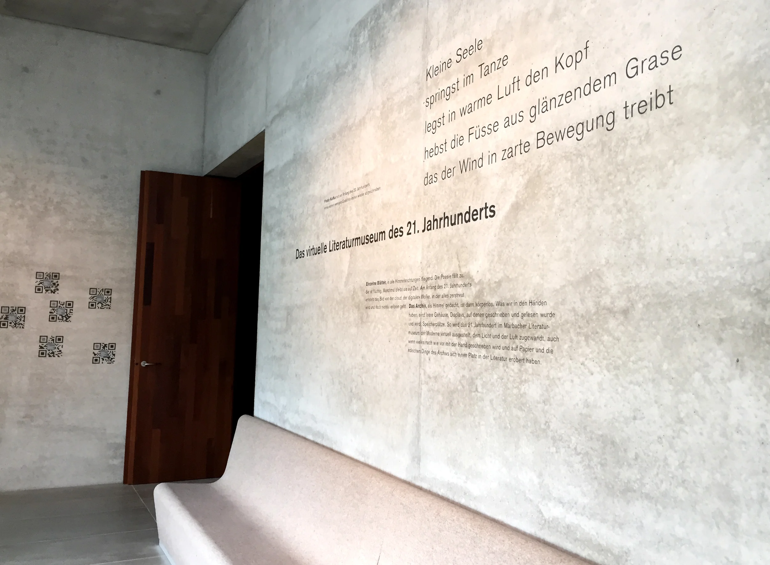 Exposed fair face concrete, graphics by Diethard Keppler applied directly to the walls, felt-clad linear seating to enjoy the view.