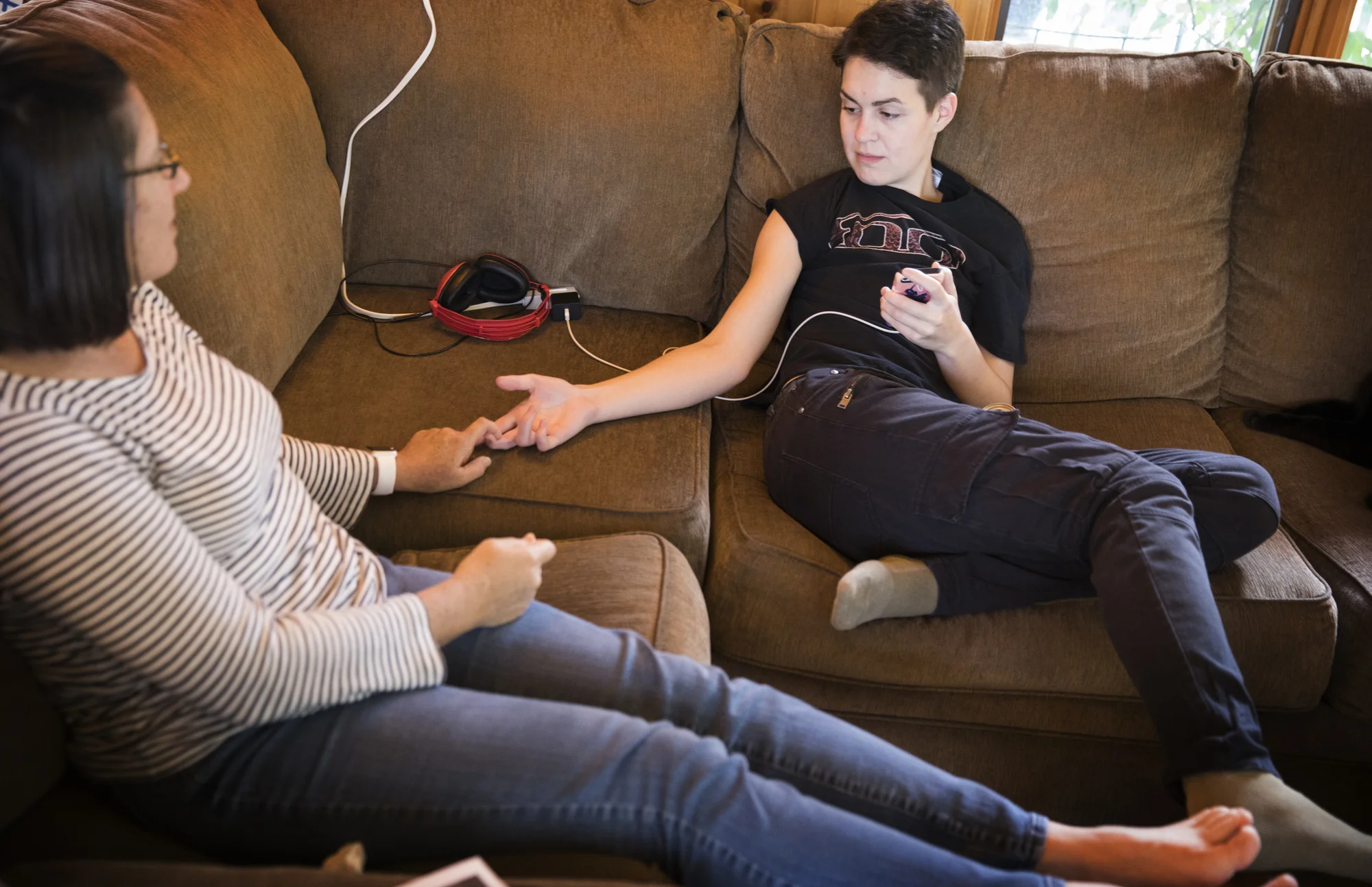 Raised by a drug-addicted mother who moved the family often, Gideon had a chaotic childhood, and his coming-of-age got off to an equally rough start. At 22, he was living in Anoka’s only homeless shelter with nowhere to go and no one to turn to. http://www.startribune.com/home-host-program-helps-homeless-teens-in-the-suburbs/443461133/ That’s when the Andersons offered him a bedroom in their Andover home, as part of the Greater Twin Cities YMCA’s Community Home Host Program. Gideon jumped at the chance to spend a year under the family’s roof in the north metro suburb. “I am just happy to have a place to lay my head at night and to be with people who enjoy my company,” said Gideon, now enrolled at Anoka-Ramsey Community College and working on getting his driver’s license. In the battle against youth homelessness, suburbs have fewer shelter beds and resources compared to big cities, and they sometimes lack the political will to offer those services. But suburbanites have one tool that city dwellers often lack: extra bedrooms. That’s why the YMCA started its home host program in Anoka County, pairing homeless youth with families willing to share a room in their homes for a year for free. The program, part of a constellation of services the Y offers for homeless youth, has gotten off to a modest start, with 10 families opening their homes to a young person. Some are finishing high school while others are trying to figure out their next step toward adulthood. The Y program provides structure and safeguards — including background checks, social workers and access to services — but is less cumbersome than taking on foster parenthood. It also allows homeless young people to stay in suburban communities where they may have grown up, rather than having to go to where services are available in Minneapolis or St. Paul. Funding comes from the state, the Greater Twin Cities United Way and the Y. “Not all young people are ready to live independently, especially if they are struggling to finish high school,” said Stacy Sweeney, the Y’s youth support program director. “They want people to encourage them. They want to be safe.” Some say it’s also a more palatable and affordable homeless solution for suburban officials, some of whom balk at additional shelter beds or affordable apartments that they believe could make their city a magnet for homeless people. “We know there is a need in the suburbs, but bricks and mortar are expensive,” said Betty Notto, the Y’s youth support program manager. It’s like a calling. The Y modeled its program after the two-decade-old GLBT Host Home Program for homeless youth that first operated at the nonprofit YouthLink and later moved to Avenues for Homeless Youth. That program has worked with about 200 young people since its inception. Family instability, including parents who are homeless or addicted, or conflicts such as those over sexual orientation, can force teens and young adults to fend for themselves. Many young people may not identify themselves as homeless. They live day-to-day by couch hopping, clandestinely camping in suburban parks, or sleeping in stairwells, cars and public bathrooms. “They’re not homeless under a bridge, but they are not safe,” Notto said. Who takes in young adults? Many are families that already volunteer and donate time and money in the community, and have a desire to give back at a deeper level. Some are motivated by faith. They range from empty nesters to people with school-age children. “It’s almost like a calling,” Notto said. The Y requires host families to have an empty bedroom with a door and to be accepting of all races and sexual orientations. It attempts to match families and individuals with similar expectations; some parties seek a roommate-style situation, while others want to share meals and family activities. Many suburbs have limited access to public transit, so young people are told up front of that limitation and other house rules. Jeff and Carolyn Anderson have opened their home to two foreign exchange students over the years. The couple taught Sunday school, and Jeff volunteered at the Hope 4 Youth’s drop-in center in Anoka. That’s where he met Gideon, who would stop by to do laundry and pick up food and supplies. Gideon, who asked that his last name not be used for reasons of safety, had moved from Illinois to Minnesota in January with plans to move in with a friend he’d made on the internet. Those plans quickly fell apart, and he landed at the Stepping Stone homeless shelter in Anoka. “It was humbling and a little bit scary,” he said. “I had nowhere to go from there.” Gideon, who is quiet and artistic, impressed Jeff. “He kept talking about Gideon,” Carolyn Anderson said. Realizing they could help a young person similar to their own three children at a critical juncture in his life, they offered him a room. “It was something else we thought we could do. We have the space and the interest,” Jeff Anderson said. The Y program provided structure and help. “We needed access to the social workers and the resources that we suburbanites don’t know about,” Jeff Anderson said. “There’s enough background checks both ways so you are not stepping into a situation you can’t handle. We have a 13-year-old son and you want to make sure it’s safe.” Gideon easily fit into the family’s daily rhythms, sharing meals, watching movies and interacting with them. He welcomed advice from the Andersons, who helped him quit a summer job that had become uncomfortable and encouraged him to enroll at Anoka-Ramsey. “ You need someone to be your advocate,” Carolyn Anderson said. “That’s what we suburban parents do for our own kids every day,” Jeff Anderson added. Gideon, who is interested in illustrations, character design and graphic novels, said the biggest challenge for him has been learning to relax and settle in. “ Let’s be honest: I have abandonment issues,” he said. “I was just worried it would all fall out from under me. I was worried it would totally crash and burn and I would lose another family.” The Andersons said they consider Gideon to be family. “We knew it was a good fit,” Jeff Anderson said."