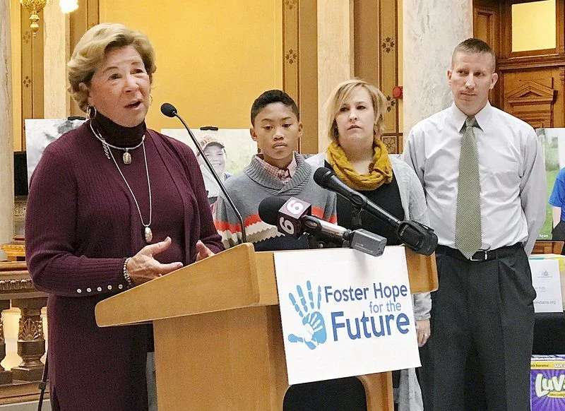 Karen Young took a year's leave from her attorney practice when she and her husband, Weston, received licenses as foster parents. http://www.heraldbulletin.com/news/state_news/house-philanthropy-focuses-on-foster-home-shortage/article_0c32b43e-dab3-557e-886b-f668d824db7a.html They became foster parents of then 4-year-old A.J. After a year, the Youngs adopted the youngster. "Children need family that love them, care for them, to give them good education so that they can get a job and have a good life. That's what my parents did for me," said A.J., now 11 and a sixth-grader at Indianapolis Public School 56. On Tuesday, the Youngs stood together in the Statehouse as Indiana House leaders announced they would focus their annual philanthropic campaign on the foster home shortage. In Indiana, nearly twice as many children are in the foster care system than there are available foster homes, according to the Indiana Department of Child Services. Currently, 150 children in Indiana are awaiting for foster care, House Speaker Brian Bosma, R-Indianapolis, said. Bosma announced the project with House Minority Leader Scott Pelath, D-Michigan City. The number of children in out-of-home care grew from 13,811 in September 2015 to 17,214 two years later, the DCS reports. "We need more foster families for children of all ages, abilities, special needs and various cultures," said Cathy Graham, executive director of the Indiana Association of Resources and Child Advocacy. The House campaign is also to urge support of Hoosiers who become foster parents. "We understand, not everyone is able today or tomorrow to be a foster or adoptive parent but everyone of us can support those folks that are stepping forward," said Sharon Pierce, president and CEO of The Villages, a foster care and adoption service. The House will collect donations, including diapers, clothes, blankets and gift cards. After adopting A.J. when he was 5, the Youngs adopted another foster child and had a biological child of their own. Legislators launched the campaign with the Indiana Association of Resources and Child Advocacy and The Villages by setting up a Twitter account at #FosterHope Indiana and a website at www.FosterHopeIndiana.org
