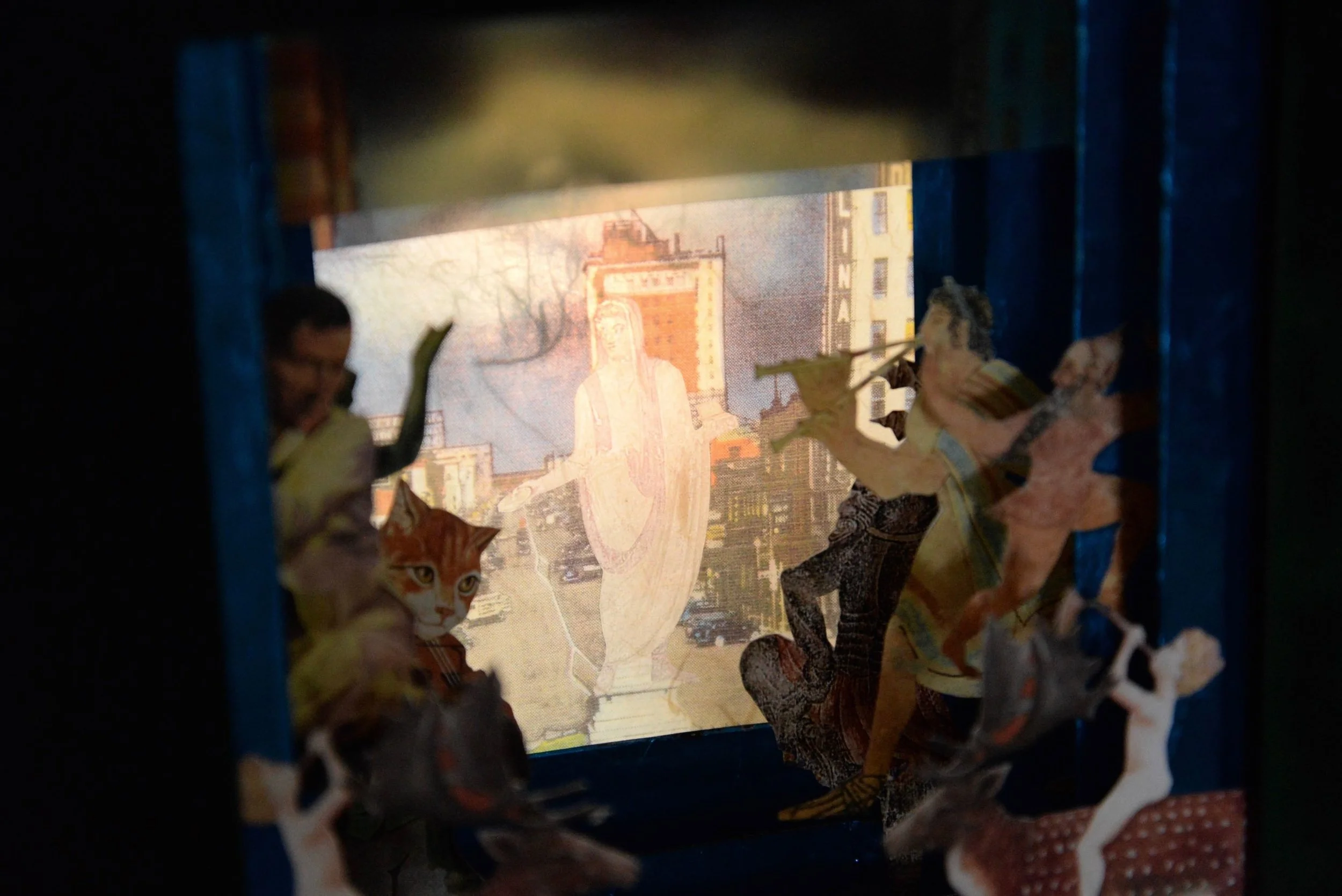 Lightbox view, Celebration, July 2014, Paper and matt board collage, 9” X 10” X 3”, 400 CAD
