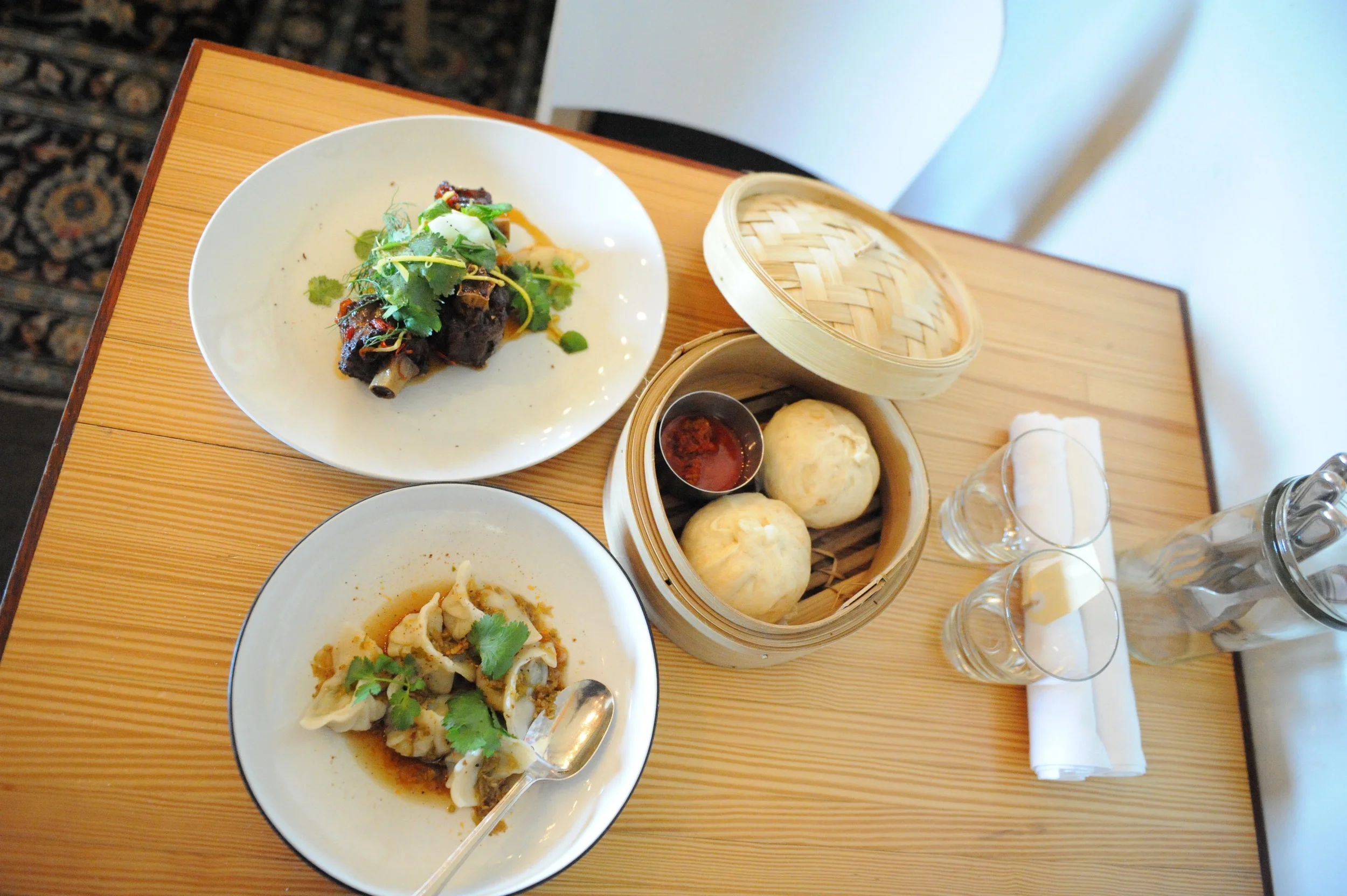 Entree selection of kangaroo tail, prawn dumplings and pork steam buns