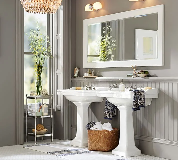 New lighting, fresh paint and a hand-painted framed mirror transform a bathroom. Photo: Pottery Barn.